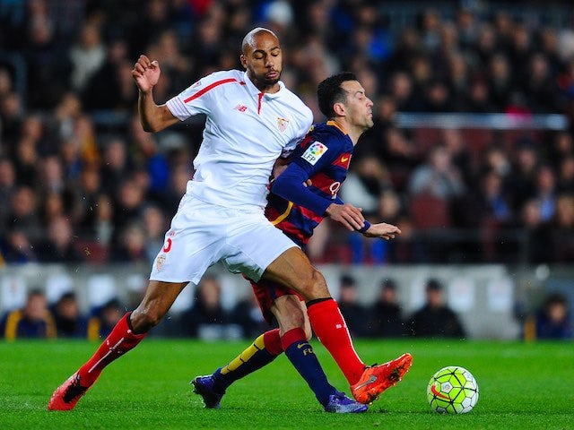 Steven N'Zonzi barges Sergio Busquets during the La Liga game between Barcelona and Sevilla on February 28, 2016