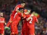 James Milner is mounted by teammates after scoring during the Premier League game between Liverpool and Manchester City on March 2, 2016