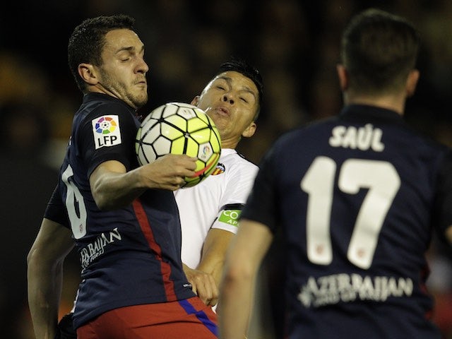 Koke and Enzo Perez clash during the La Liga game between Valencia and Atletico Madrid on March 6, 2016