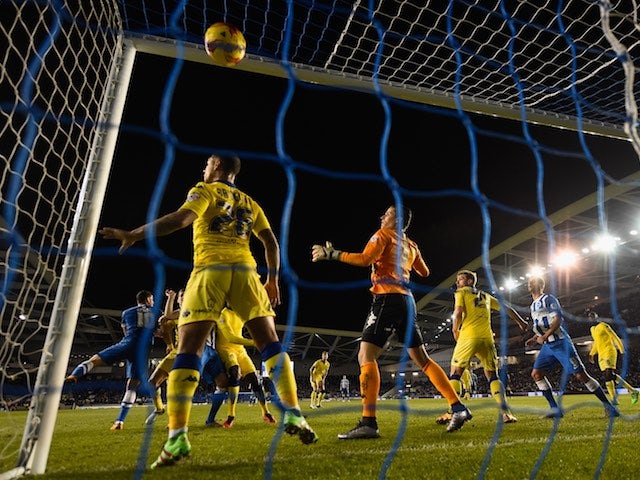 Lewis Dunk heads in his side's fourth during the Championship game between Brighton & Hove Albion and Leeds United on February 29, 2016