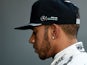Lewis Hamilton stands in the paddock during a press conference at the Circuit de Catalunya on February 25, 2016