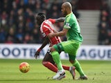 Sadio Mane controls the ball under pressure of Younes Kaboul during the Premier League match between Southampton and Sunderland at St Mary's Stadium on March 5, 2016