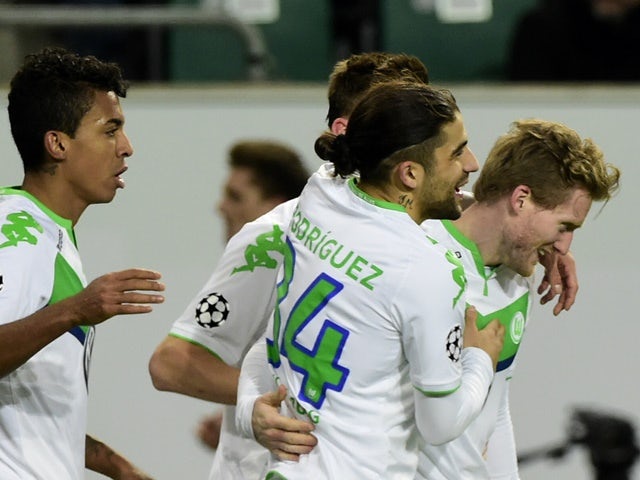 Wolfsburg's striker Andre Schurrle and teammates react after scoring during the second-leg round-of-16 Champions League match against Gent on March 8, 2016