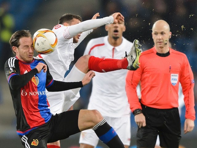 Basel's Luca Zuffi heads the ball next to Sevilla's Sebastian Cristoforo during the Europa League round of 16 first leg football match at the St Jakob Stadium on March 10, 2016