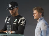 Nico Rosberg leaves the stage behind Lewis Hamilton during a press conference for the kickoff of the new Formula 1 season in Fellbach, south-western Germany, on March 11, 2016