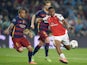 Alex Iwobi and Dani Alves in action during the Champions League round-of-16 second leg between Barcelona and Arsenal on March 16, 2016
