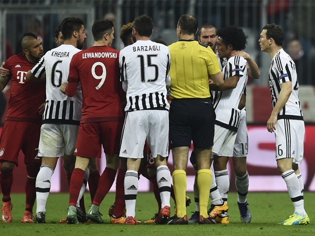 Referee Jonas Eriksson breaks up a scuffle during the Champions League round-of-16 second leg between Bayern Munich and Juventus on March 16, 2016