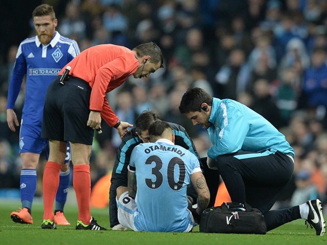 Manchester City's Nicolas Otamendi receives medical treatment before leaving the pitch injured against Dynamo Kiev on March 15, 201