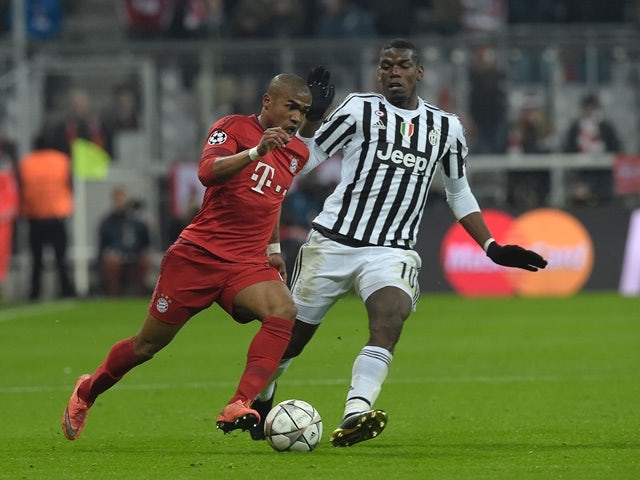 Paul Pogba and Douglas Costa in action during the Champions League round-of-16 second leg between Bayern Munich and Juventus on March 16, 2016
