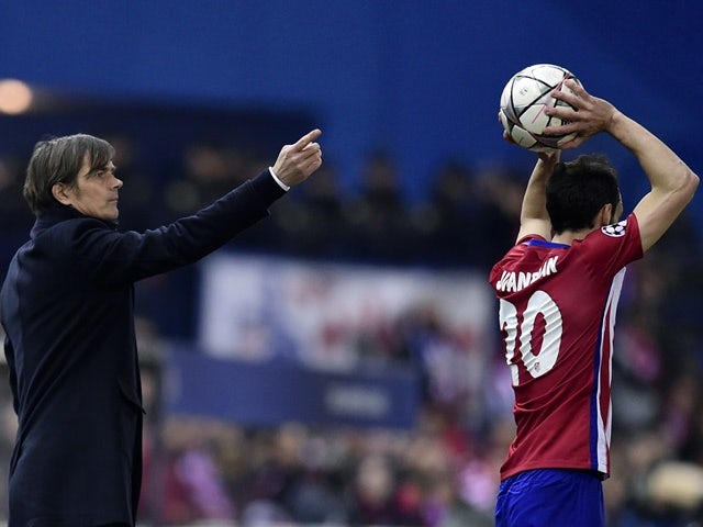 PSV Eindhoven coach Phillip Cocu points as Atletico Madrid's Diego Godin throws the ball on March 15, 2016