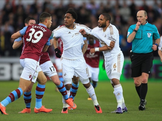 Rudy Gestede and Ashley Williams have a scuffle during the Premier League game between Swansea City and Aston Villa on March 19, 2016