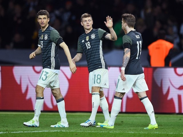 Toni Kroos celebrates with Thomas Muller and Marco Reus during the international friendly between Germany and England on March 26, 2016