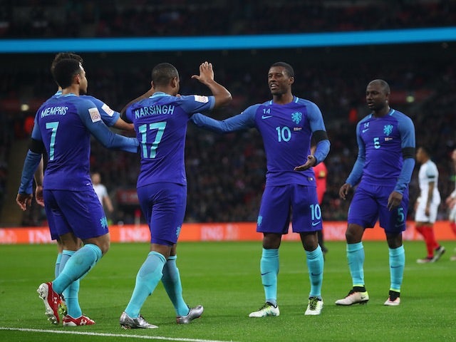 Netherlands players celebrate a goal against England at Wembley on March 29, 2016