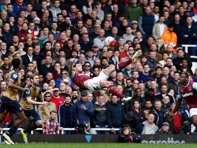 Andy Carroll attempts an overhead kick during the Premier League game between West Ham United and Arsenal on April 9, 2016