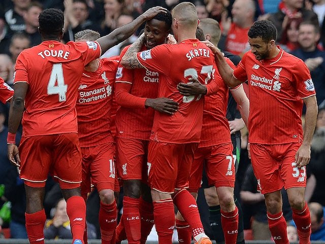 Divock Origi celebrates the fourth goal with teammates during the Premier League game between Liverpool and Stoke City on April 10, 2016
