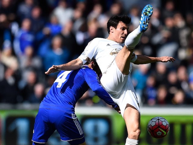 Big Jack Cork and Cesc Fabregas in action during the Premier League game between Swansea City and Chelsea on April 9, 2016