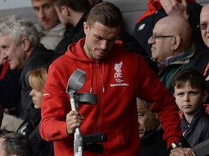 Jordan Henderson arrives on crutches in the stands during the Premier League game between Liverpool and Stoke City on April 10, 2016