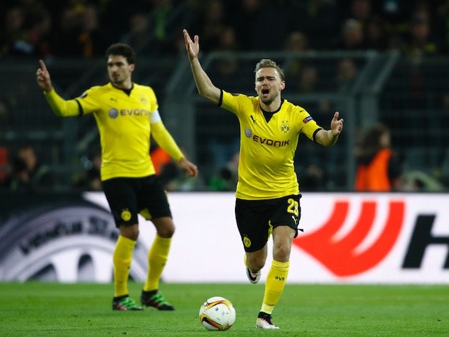 Matthias Ginter and Mats Hummels protest during the Europa League quarter-final between Borussia Dortmund and Liverpool on April 7, 2016
