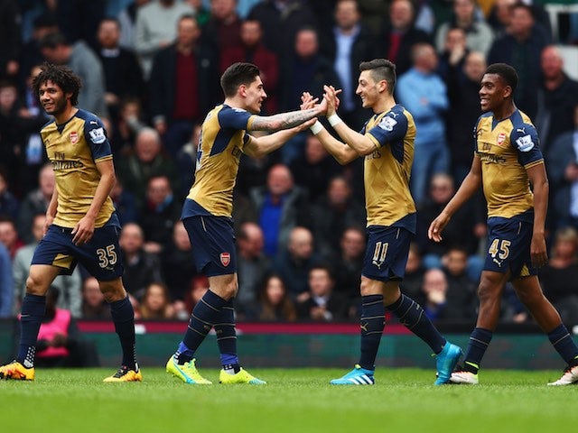 Mesut Ozil celebrates scoring with Hector Bellerin during the Premier League game between West Ham United and Arsenal on April 9, 2016