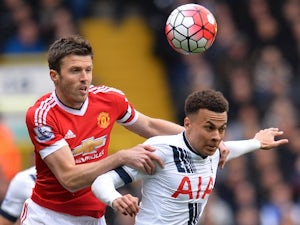 Michael Carrick challenges Dele Alli during the Premier League game between Tottenham Hotspur and Manchester United on April 10, 2016