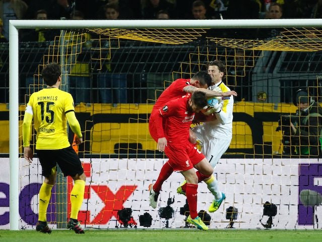 Roman Weidenfeller collides with Dejan Lovren during the Europa League quarter-final between Borussia Dortmund and Liverpool on April 7, 2016
