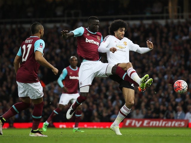 Cheikhou Kouyate and Marouane Fellaini in action during the FA Cup replay between West Ham United and Manchester United on April 13, 2016