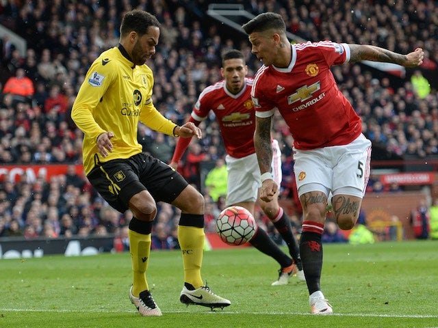 Marcos Rojo and Joleon Lescott in action during the Premier League game between Manchester United and Aston Villa on April 16, 2016