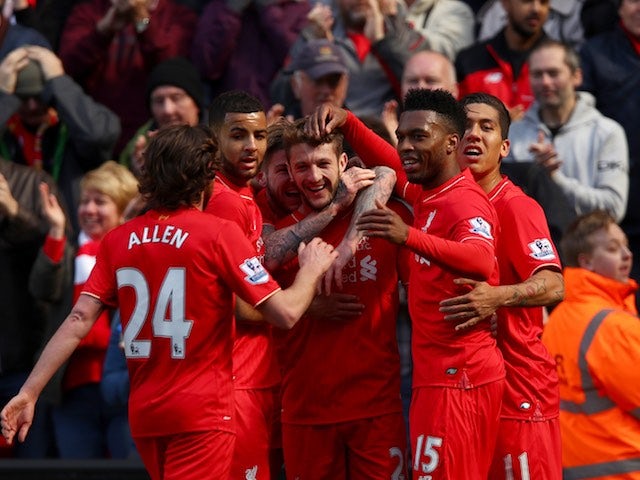 Adam Lallana celebrates with teammates after scoring during the Premier League game between Liverpool and Newcastle United on April 23, 2016