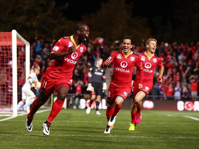 Bruce Djite of Adelaide United celebrates with teammates after scoring a goal during the A-League semi-final against Melbourne City at Coopers Stadium on April 22, 2016