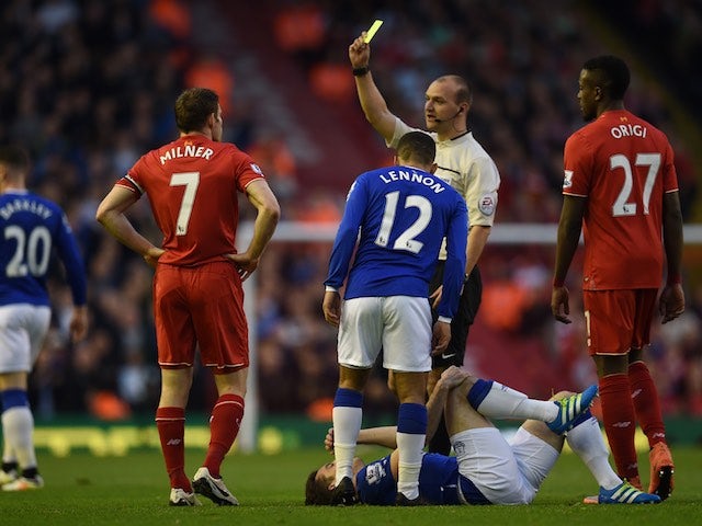 James Milner is served with a yellow during the Premier League game between Liverpool and Everton on April 20, 2016