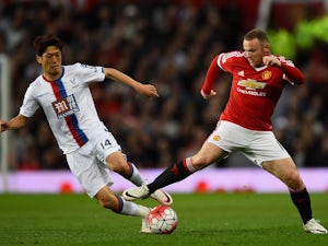 Lee Chung-yong and Wayne Rooney in action during the Premier League game between Manchester United and Crystal Palace on April 20, 2016