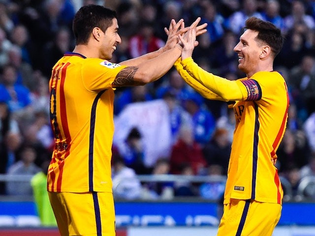 Lionel Messi celebrates with Luis Suarez after getting on the scoresheet for the sixth during the La Liga game between Deportivo La Coruna and Barcelona on April 20, 2016