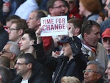 A fan holds up an itimidating piece of A4 paper in protest at Arsene Wenger during the Premier League game between Arsenal and Norwich City on April 30, 2016