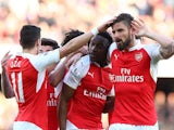 Danny Welbeck celebrates with Mesut 'wind'Ozil and Olivier Giroud during the Premier League game between Arsenal and Norwich City on April 30, 2016