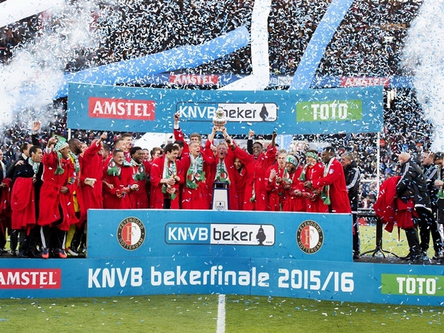 Feyenoord's players celebrate with the trophy on the podium after winning the Dutch cup final football match against FC Utrecht on April 24, 2016