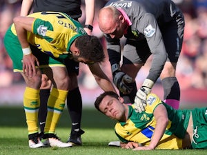 Ivo Pinto and John Ruddy console Jonny Howson during the Premier League game between Arsenal and Norwich City on April 30, 2016