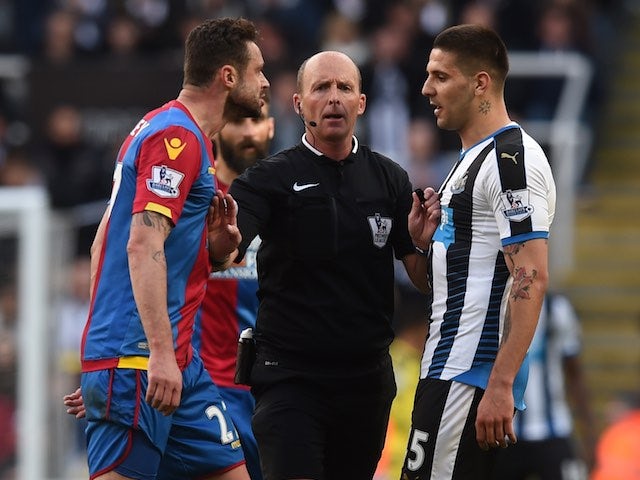 Mike Dean stunningly separates Damien Delaney and Aleksandar Mitrovic during the Premier League game between Newcastle United and Crystal Palace on April 30, 2016