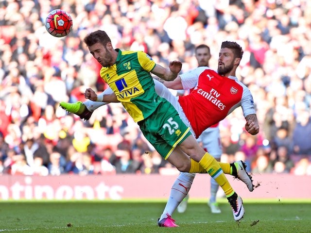Olivier Giroud gives it to Ivo Pinto during the Premier League game between Arsenal and Norwich City on April 30, 2016