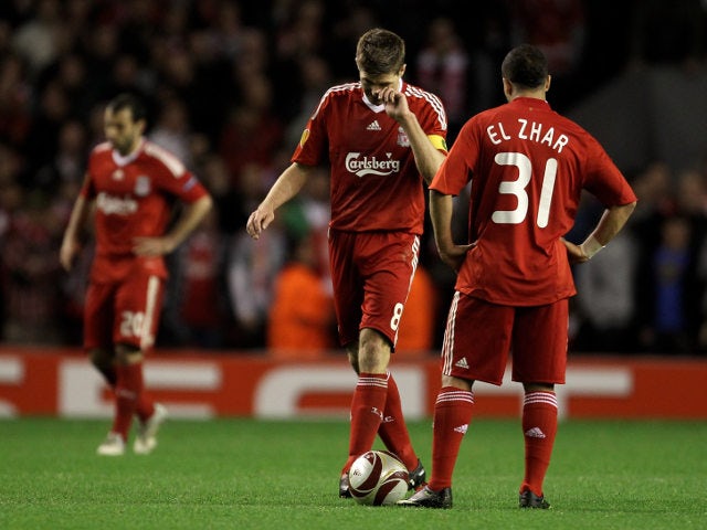 Liverpool legends Steven Gerrard and Nabil El Zhar look disappointed following their Europa League semi-final exit at the hands of Atletico Madrid in 2009-10