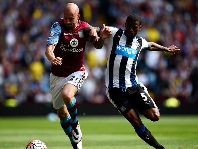 Alan Hutton and Georginio Wijnaldum in action during the Premier League match between Aston Villa and Newcastle United on May 7, 2016