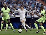 Real Madrid's Gareth Bale bursts past Eliaquim Mangala and Fernando of Manchester City during the Champions League semi-final second leg at the Bernabeu on May 4, 2016