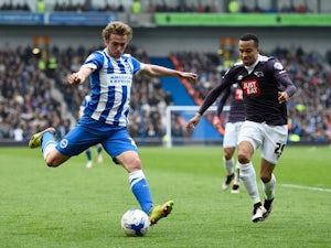 James Wilson of Brighton & Hove Albion takes a shot on goal under pressure from Marcus Olsson of Derby County on May 2, 2016