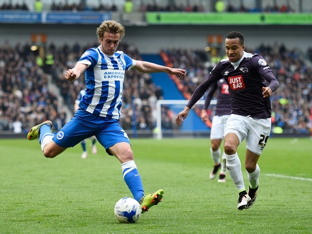 James Wilson of Brighton & Hove Albion takes a shot on goal under pressure from Marcus Olsson of Derby County on May 2, 2016