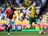 Juan Mata and Robbie Brady in action during the Premier League game between Norwich City and Manchester United on May 7, 2016