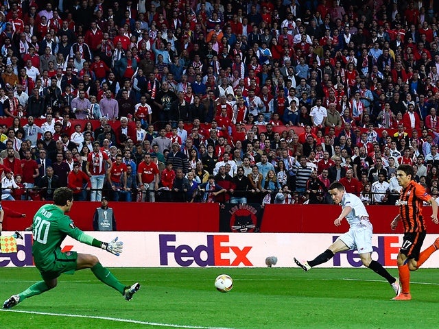 Kevin Gameiro of Sevilla scores the opening goal past Maksym Malyshev and Andriy Pyatov of Shakhtar Donetsk during the UEFA Europa League semi-final second leg on May 5, 2016
