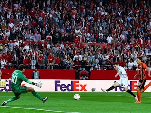 Kevin Gameiro of Sevilla scores the opening goal past Maksym Malyshev and Andriy Pyatov of Shakhtar Donetsk during the UEFA Europa League semi-final second leg on May 5, 2016