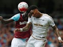 Leroy Fer and Cheikhou Kouyate vie in the air during the Premier League match between West Ham United and Swansea City on May 7, 2016