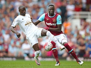 Modou Barrow and Cheikhou Kouyate in action during the Premier League match between West Ham United and Swansea City on May 7, 2016