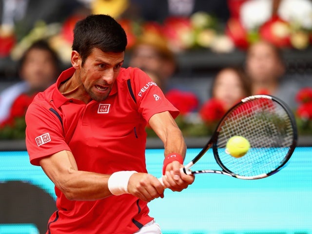 Novak Djokovic plays a backhand against Roberto Bautista Agut in their third-round match during day six of the Mutua Madrid Open on May 5, 2016