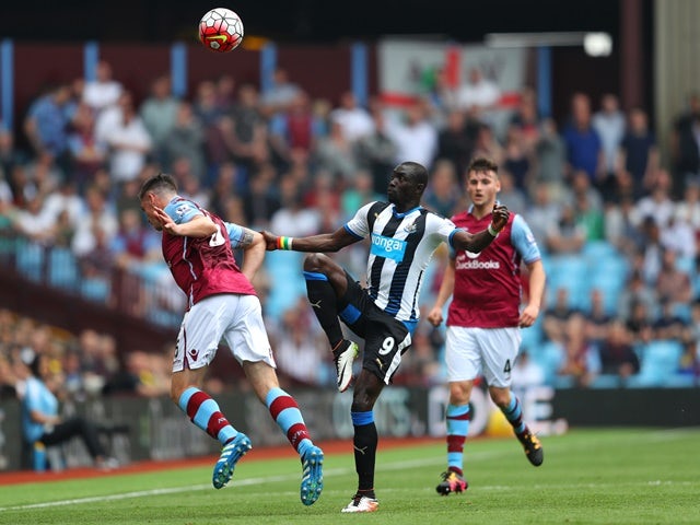 Papiss Cisse and Ciaran Clark in action during the Premier League match between Aston Villa and Newcastle United on May 7, 2016